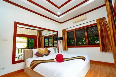 a bedroom with a bed with a red hat on it at Lovely,Private 7 bedroom pool villa Kamala in Kamala Beach