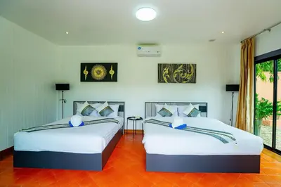 two beds in a room with two at Lovely,Private 7 bedroom pool villa Kamala in Kamala Beach