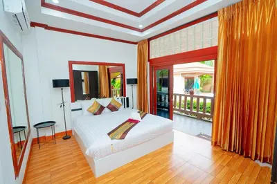 a bedroom with a white bed and a balcony at Lovely,Private 7 bedroom pool villa Kamala in Kamala Beach