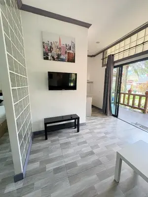 a living room with a television and a tiled floor at Lovely,Private 7 bedroom pool villa Kamala in Kamala Beach