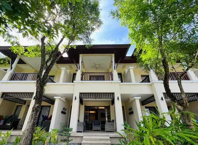 an exterior view of a house with trees at Laguna Village by RESAVA in Layan Beach