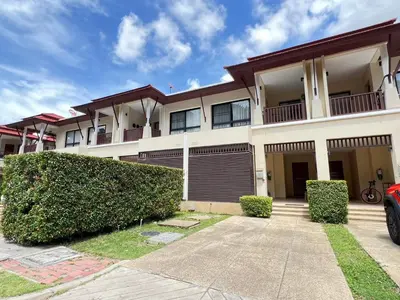 a large white building with bushes in front of it at Laguna Village by RESAVA in Layan Beach