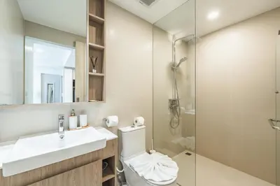 a bathroom with a toilet and a sink and a shower at Идеальные апартаменты в Laguna Skypark in Phuket Town