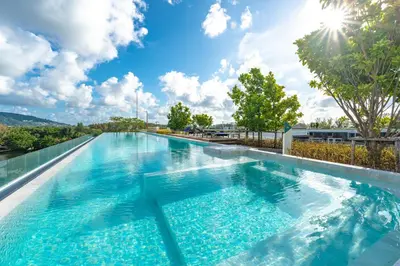 a large swimming pool with blue water on top of a building at Идеальные апартаменты в Laguna Skypark in Phuket Town