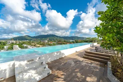 a swimming pool on the roof of a building at Идеальные апартаменты в Laguna Skypark in Phuket Town