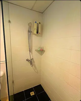 a shower with a glass door in a bathroom at Patong Tower Apartments By Tida in Patong Beach