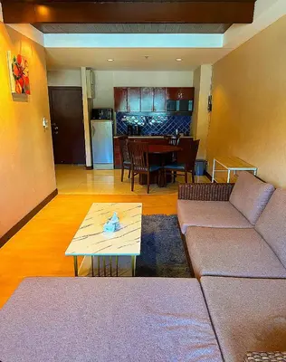 a living room with a couch and a table at Patong Tower Apartments By Tida in Patong Beach