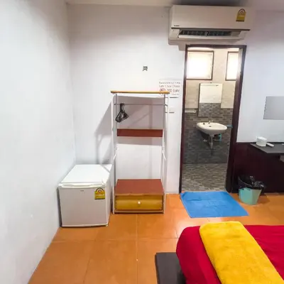 a room with a bed and a bathroom with a sink at Happy House in Phi Phi Don