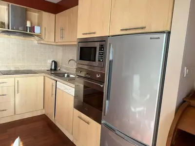 a kitchen with a stainless steel refrigerator and a microwave at Patong Tower apartment with a great view in Patong Beach