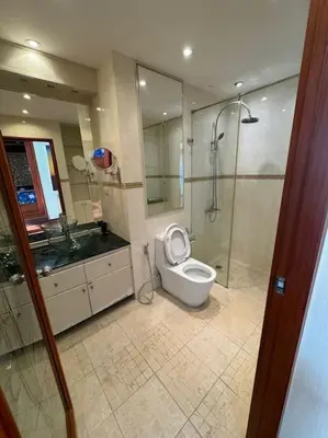 a bathroom with a toilet and a shower and a sink at Patong Tower apartment with a great view in Patong Beach