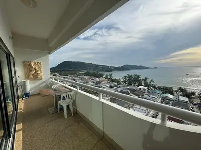 a balcony with a table and a view of a marina at Patong Tower apartment with a great view in Patong Beach