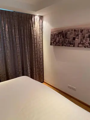 a bedroom with a bed and a window at Sea View One Bedroom Condo in Kata Beach in Kata Beach