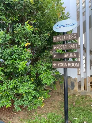a street sign in front of a bush at Sea View One Bedroom Condo in Kata Beach in Kata Beach