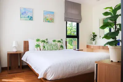 a bedroom with a white bed and a window at Big Garden Townhouse Laguna Park in Phuket Town