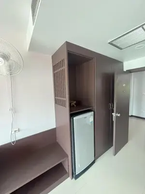 a small kitchen with a refrigerator and a fan at Chollada Inn in Kamala Beach
