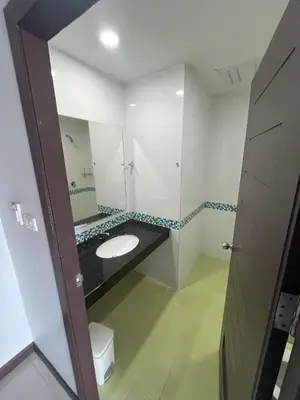 a bathroom with a sink and a mirror at Chollada Inn in Kamala Beach