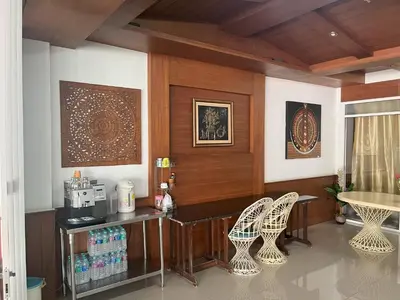 a living room with a table and two chairs at Chollada Inn in Kamala Beach