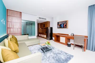 a living room with a couch and a table at Fishermens Harbour Urban Resort - SHA Extra Plus in Patong Beach