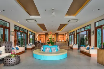 a lobby of a resort with a round table at Fishermens Harbour Urban Resort - SHA Extra Plus in Patong Beach