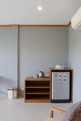 a kitchen with a counter and a refrigerator in a room at Moonlight Cottage in Ban Pa Khlok