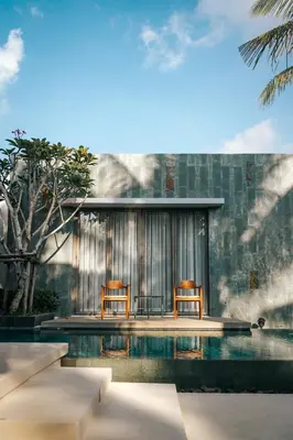 two chairs sitting next to a swimming pool at Allure Villa in Bangtao in Ban Pak Lak