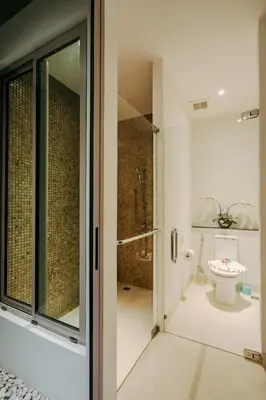 a bathroom with a shower and a toilet at Luxury Penthouse Apartment 8C at Kata Gardens in Kata Beach