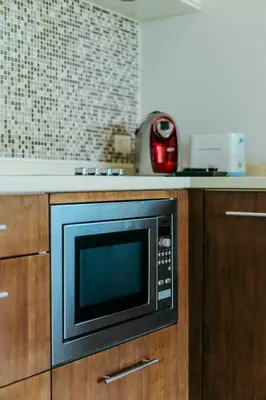 a microwave oven sitting on top of a kitchen counter at Luxury Penthouse Apartment 8C at Kata Gardens in Kata Beach