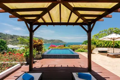 an outdoor patio with a pool and a pergola at Luxury Penthouse Apartment 8C at Kata Gardens in Kata Beach