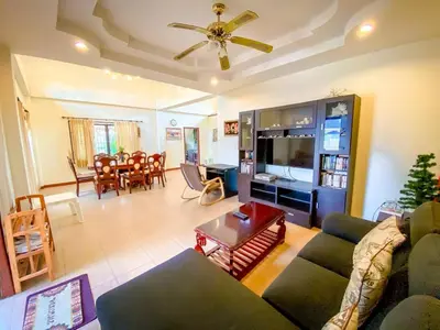 a living room with a couch and a table at Garden & private pool house in Surin Beach