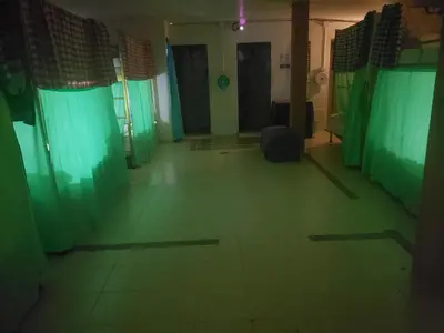 a dark room with green curtains and a room with a room at Lucky Dorm in Phi Phi Don