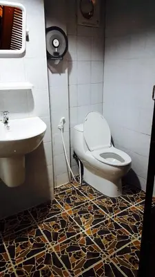 a bathroom with a toilet and a sink at Lucky Dorm in Phi Phi Don
