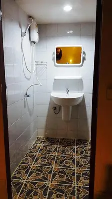 a bathroom with a sink and a mirror at Lucky Dorm in Phi Phi Don