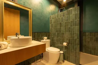 a bathroom with a sink and a toilet and a mirror at New Ultra Modern Designer Furniture Gym #v62 in Chalong