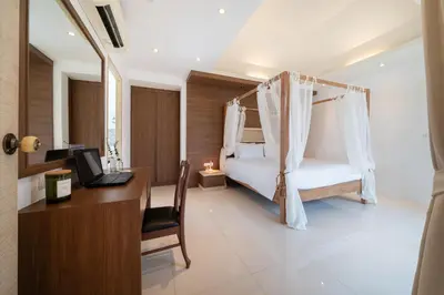 a bedroom with a bed with a desk and a laptop at Bangtao Beach Villa with a Long pool 12 meters in Phuket Town
