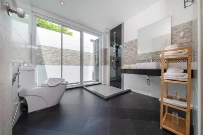 a bathroom with a white toilet and a sink at Bangtao Beach Villa with a Long pool 12 meters in Phuket Town
