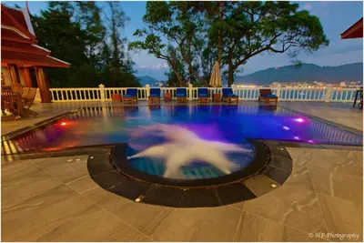 a swimming pool with a fountain in the middle at Villa REGTUK in Patong Beach