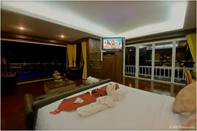 a hotel room with a bed and a television at Villa REGTUK in Patong Beach