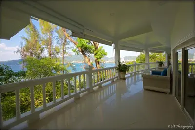 a white porch with a view of the water at Villa REGTUK in Patong Beach