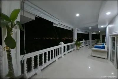 a balcony with a view of the city at night at Villa REGTUK in Patong Beach