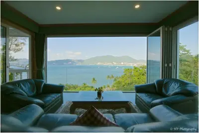 a living room with a view of the ocean at Villa REGTUK in Patong Beach