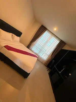 a small bedroom with a bed and a window at Vi Stay in Phuket Town