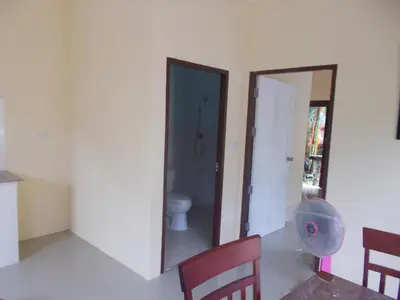 a room with a bathroom with a toilet and a window at Absolute calm for long sleepers and others in Kamala Beach