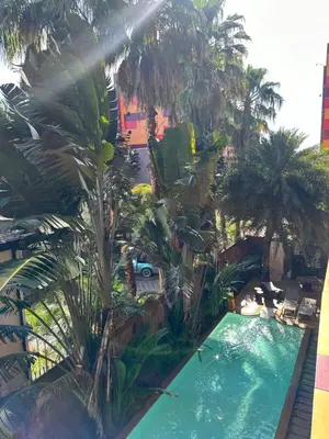 an overhead view of a swimming pool with palm trees at Nai Harn Beach Condo (C2) in Rawai Beach