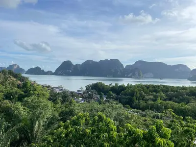 a view of a body of water with mountains in the background at Green Tree Cottage3 in Klong Muang Beach
