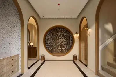 a hallway with arches and a wall with a large window at Arco Phuket Town in Phuket Town