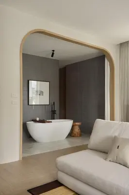 a bathroom with a bath tub and a white couch at Arco Phuket Town in Phuket Town