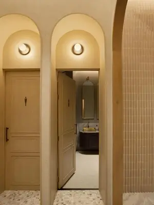 a bathroom with two arched doors and a mirror at Arco Phuket Town in Phuket Town