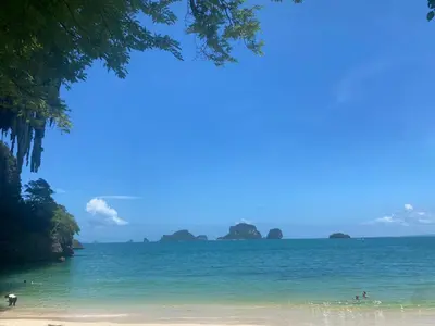 a view of a beach with people in the water at Green Tree Cottage 4 in Klong Muang Beach