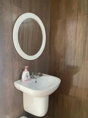 a bathroom with a white sink and a mirror at Green Tree Cottage 4 in Klong Muang Beach