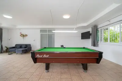 a pool table in the middle of a room at Villa Olympus Ocean Vista Kata Beach in Kata Beach